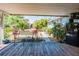 Spacious back deck showcasing a well-manicured yard with lush greenery and a comfortable seating area at 1061 Lowry Ave, Lakeland, FL 33801