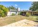 View of the backyard with a covered patio, storage shed, and mature landscaping at 1061 Lowry Ave, Lakeland, FL 33801