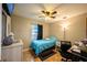 Simple bedroom with a ceiling fan, window, and a desk area at 1061 Lowry Ave, Lakeland, FL 33801