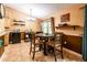 Cozy dining area with natural light, tile floors, and a dining table perfect for Gathering meals and entertaining at 1061 Lowry Ave, Lakeland, FL 33801