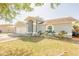 Charming home exterior features a well-manicured lawn, arched entry, and attached two-car garage at 1061 Lowry Ave, Lakeland, FL 33801