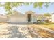 Charming single-story home with a well-maintained lawn and a two-car garage, perfect for a Gathering at 1061 Lowry Ave, Lakeland, FL 33801