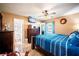 Comfortable main bedroom featuring a ceiling fan, ensuite bathroom, and plenty of storage at 1061 Lowry Ave, Lakeland, FL 33801