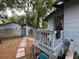 Landscaped backyard featuring a patio area, with privacy fence, and lush greenery at 1217 King Ave, Lakeland, FL 33803