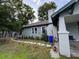 Side of home with patio and seating, trimmed plants, and partial lawn at 1217 King Ave, Lakeland, FL 33803