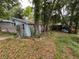 Shaded backyard with shed, fence, and small outdoor structure at 1217 King Ave, Lakeland, FL 33803
