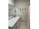 Bathroom featuring a sleek granite countertop, white cabinetry, and updated fixtures at 1217 King Ave, Lakeland, FL 33803
