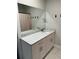 Modern bathroom featuring granite counters, white cabinetry, and a large mirror at 1217 King Ave, Lakeland, FL 33803