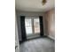 Well-lit bedroom with windows, featuring an accent wall, carpeted floor, and neutral decor at 1217 King Ave, Lakeland, FL 33803