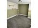 Cozy bedroom featuring a carpeted floor, open closet, and custom shelves for storage and display at 1217 King Ave, Lakeland, FL 33803