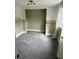 Spacious walk-in closet features carpeted flooring, built-in shelves, and natural light at 1217 King Ave, Lakeland, FL 33803