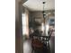 Dining room is highlighted with a black table, chandelier, and lovely natural light at 1217 King Ave, Lakeland, FL 33803