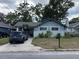 Charming home with a driveway, mailbox, and lush trees at 1217 King Ave, Lakeland, FL 33803