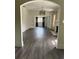 Living room featuring a decorative fireplace, modern chandelier, and an arched doorway at 1217 King Ave, Lakeland, FL 33803