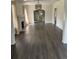 Bright living room featuring a decorative fireplace, arched doorway, and modern flooring at 1217 King Ave, Lakeland, FL 33803