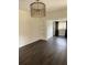 Bright living room with a built-in bookshelf, stylish chandelier, and modern flooring at 1217 King Ave, Lakeland, FL 33803