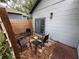 Cozy patio with outdoor seating and decorative wood fencing, ideal for relaxing or entertaining at 1217 King Ave, Lakeland, FL 33803
