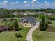 Expansive home on a meticulously landscaped lot with a winding driveway at 130 Sylvana Ct, Auburndale, FL 33823