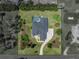 Stunning aerial view of property featuring a pool, lush landscaping, and a private backyard at 130 Sylvana Ct, Auburndale, FL 33823