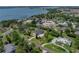 An aerial view of home on a large lot with mature trees and lush landscaping at 130 Sylvana Ct, Auburndale, FL 33823