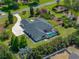 Aerial view of home with screened pool enclosure on a manicured lot at 130 Sylvana Ct, Auburndale, FL 33823