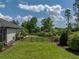 Large fenced-in backyard featuring lush green grass and tropical landscaping at 130 Sylvana Ct, Auburndale, FL 33823