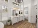 Bright bathroom with dual sinks, vanity, and modern lighting fixtures at 130 Sylvana Ct, Auburndale, FL 33823