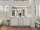 Beautiful bathroom with dual sinks, quartz countertop, and modern lighting fixtures at 130 Sylvana Ct, Auburndale, FL 33823