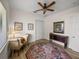 Bedroom featuring hardwood floors, a ceiling fan, a window, and closet at 130 Sylvana Ct, Auburndale, FL 33823