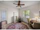 Cozy bedroom featuring wood floors, a ceiling fan, and natural light at 130 Sylvana Ct, Auburndale, FL 33823
