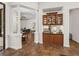 Dining area featuring decorative columns and offering access to the pool and kitchen at 130 Sylvana Ct, Auburndale, FL 33823