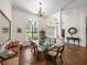 Bright dining room featuring a large window, glass table, and stylish decor perfect for entertaining guests at 130 Sylvana Ct, Auburndale, FL 33823