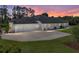 Rear exterior view of home showing large driveway and three-car garage at 130 Sylvana Ct, Auburndale, FL 33823
