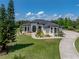 Elegant home featuring manicured landscaping, circular driveway, and timeless architectural design at 130 Sylvana Ct, Auburndale, FL 33823
