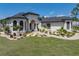 Charming single-story home featuring manicured landscaping, a well-maintained lawn, and a welcoming walkway at 130 Sylvana Ct, Auburndale, FL 33823