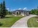 Beautiful home featuring manicured landscaping, circular driveway, and timeless architectural design at 130 Sylvana Ct, Auburndale, FL 33823