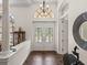 Inviting foyer with decorative tile flooring, ornate double doors, and elegant lighting fixtures at 130 Sylvana Ct, Auburndale, FL 33823