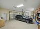 Spacious three car garage with ample storage and modern car at 130 Sylvana Ct, Auburndale, FL 33823
