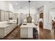 Spacious kitchen featuring tile flooring, granite countertops, stainless steel appliances, and large kitchen island at 130 Sylvana Ct, Auburndale, FL 33823