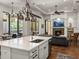 Open-concept kitchen flows to living area and showcases granite countertops and stainless steel appliances at 130 Sylvana Ct, Auburndale, FL 33823