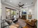 Inviting living room with a fireplace, custom built-ins, and access to the outdoor pool area at 130 Sylvana Ct, Auburndale, FL 33823