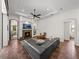 Elegant living room featuring a fireplace, built-ins, and a view into the enclosed lanai at 130 Sylvana Ct, Auburndale, FL 33823
