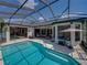 Inviting swimming pool with large patio, outdoor grill, and screened enclosure at 130 Sylvana Ct, Auburndale, FL 33823