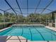 A refreshing pool with a decorative mosaic tile wall awaits in a screened enclosure at 130 Sylvana Ct, Auburndale, FL 33823
