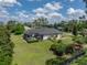 Back exterior of home featuring a screened pool and large fenced in backyard at 130 Sylvana Ct, Auburndale, FL 33823