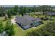Back exterior of home featuring a large screened pool and view of the backyard at 130 Sylvana Ct, Auburndale, FL 33823