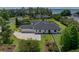 Expansive single story home featuring mature landscaping, large driveway, and three car garage at 130 Sylvana Ct, Auburndale, FL 33823