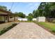 View of the backyard patio with a small storage shed, grass, and a white fence in the background at 137 Leitha Way, Lakeland, FL 33809