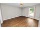 Bedroom with hardwood floors, neutral-toned walls, a modern ceiling fan and a window at 137 Leitha Way, Lakeland, FL 33809
