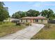 Single-story home featuring a well-manicured front yard with a distinctive bull statue at 137 Leitha Way, Lakeland, FL 33809